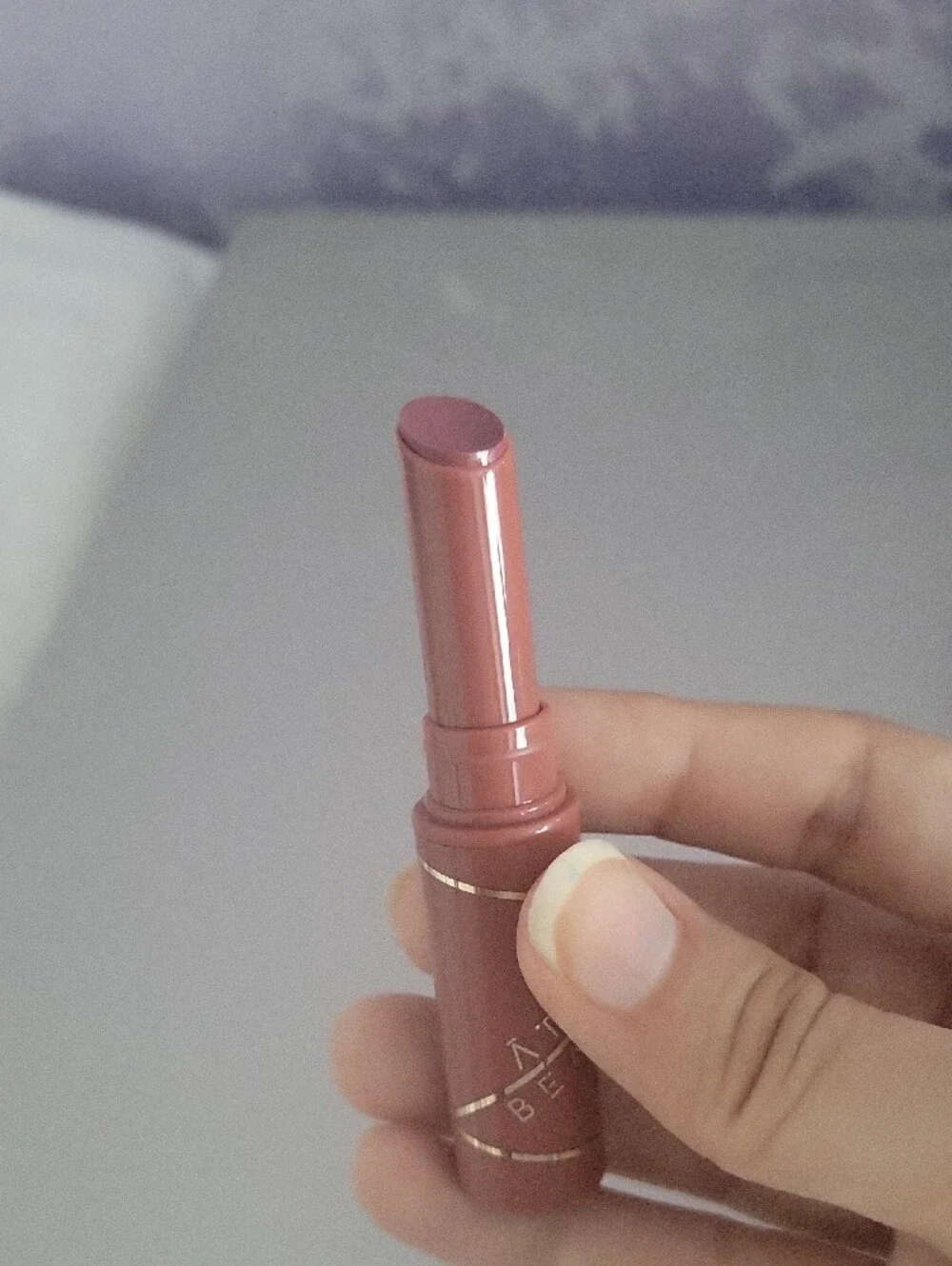 Aura Nude Pink Lipstick Tube with Gold Accents